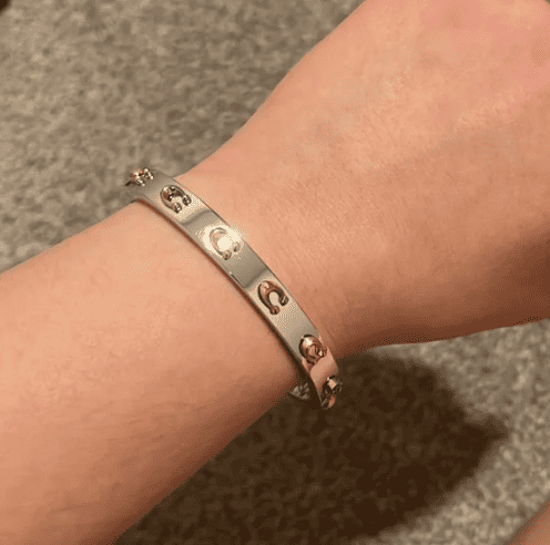 Pegged Signature Hinged Bangle by Coach 